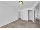 Bright bedroom with neutral carpet, closet, and adjacent bathroom, offering a cozy space at 124 Wynntry Dr, Henderson, NV 89074