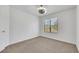 Carpeted bedroom featuring a modern light fixture and natural light from a window at 124 Wynntry Dr, Henderson, NV 89074
