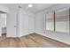 Bright bedroom with a ceiling fan, wood floors, a window with blinds, and a closet at 124 Wynntry Dr, Henderson, NV 89074