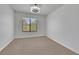 This bedroom is carpeted and features a modern ceiling fan and window at 124 Wynntry Dr, Henderson, NV 89074