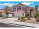 Charming two-story home featuring a red tile roof and well-maintained landscaping at 124 Wynntry Dr, Henderson, NV 89074