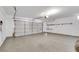 Spacious garage with epoxy flooring and a large, functional garage door at 124 Wynntry Dr, Henderson, NV 89074