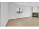 Living room features tile floors, large window, and cozy fireplace at 124 Wynntry Dr, Henderson, NV 89074