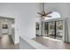 Bright living room with tile floors, fan, and sliding doors to the pool area at 124 Wynntry Dr, Henderson, NV 89074