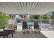 Relaxing covered patio seating area with clear views of the sparkling backyard pool at 124 Wynntry Dr, Henderson, NV 89074