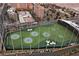Aerial view of a Topgolf driving range with vibrant green turf and recreational facilities at 125 E Harmon Ave # 318, Las Vegas, NV 89109