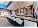 Upscale bar area with marble countertop, multiple stools and a fully stocked liquor cabinet at 125 E Harmon Ave # 318, Las Vegas, NV 89109