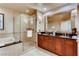 Elegant bathroom with double vanity, soaking tub, and glass-enclosed shower at 125 E Harmon Ave # 318, Las Vegas, NV 89109