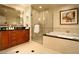 Elegant bathroom with double vanity, soaking tub, and glass-enclosed shower at 125 E Harmon Ave # 318, Las Vegas, NV 89109