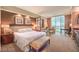 Bright main bedroom featuring a king-sized bed, a seating area, and city views at 125 E Harmon Ave # 318, Las Vegas, NV 89109