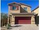 Two-story home showcasing a two-car garage, well-kept landscaping and desert plants at 1433 Gable Falls Pl # 95, North Las Vegas, NV 89084