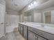 Well-lit bathroom featuring double sinks, large mirror, and shower-tub combination at 1525 Spiced Wine Ave # 19103, Henderson, NV 89074