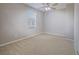 Bright bedroom with carpet, neutral walls, ceiling fan, and large window creating a welcoming atmosphere at 1525 Spiced Wine Ave # 19103, Henderson, NV 89074