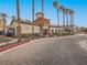 Attractive clubhouse entrance with mature palm trees lining the walkway and adjacent parking at 1525 Spiced Wine Ave # 19103, Henderson, NV 89074