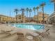 Resort-style community pool surrounded by lounge chairs and swaying palm trees at 1525 Spiced Wine Ave # 19103, Henderson, NV 89074