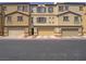 Charming townhouse with tan exterior, brown trim, and attached garages, ideal for modern living at 1525 Spiced Wine Ave # 19103, Henderson, NV 89074
