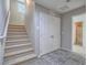 Hallway featuring tile flooring, carpeted stairs, and entry to bathroom at 1525 Spiced Wine Ave # 19103, Henderson, NV 89074