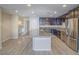 Modern kitchen featuring stainless steel appliances, granite countertops, and spacious island perfect for entertaining at 1525 Spiced Wine Ave # 19103, Henderson, NV 89074