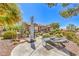Beautiful backyard features a patio with mature landscaping, walkway, and lounge chairs at 1564 Fieldbrook St, Henderson, NV 89052