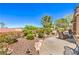 Expansive backyard with desert landscaping, rock features, and outdoor seating area at 1564 Fieldbrook St, Henderson, NV 89052