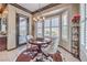 Bright dining area featuring a modern chandelier, sunny windows with shutters and stylish decor at 1564 Fieldbrook St, Henderson, NV 89052
