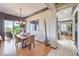 Bright dining room with patio access, chandelier, and a decorative mirror wall feature at 1564 Fieldbrook St, Henderson, NV 89052
