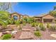 Beautiful single-story home featuring lush landscaping and a brick walkway leading to the front door at 1564 Fieldbrook St, Henderson, NV 89052