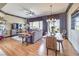 Open-concept living and dining area with hardwood floors, a ceiling fan, and large windows at 1564 Fieldbrook St, Henderson, NV 89052