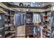 Organized walk-in closet with custom shelving, hanging rods, and ample storage space at 1564 Fieldbrook St, Henderson, NV 89052