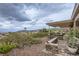 Landscaped backyard features a covered patio, desert landscaping and views of surrounding mountains at 2110 King Mesa Dr, Henderson, NV 89012