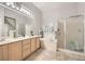 Bright bathroom featuring double sinks, a soaking tub, and a separate shower at 2110 King Mesa Dr, Henderson, NV 89012