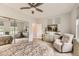 Bright bedroom featuring ceiling fan, neutral paint, tile floors, and lots of natural light from two large windows at 2110 King Mesa Dr, Henderson, NV 89012