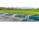 A driving range with green mats and metal frames on a sunny day with green fields in the background at 2110 King Mesa Dr, Henderson, NV 89012