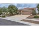 Charming single-story home showcasing a three-car garage, a well-maintained lawn, and a neutral color palette at 2110 King Mesa Dr, Henderson, NV 89012