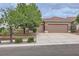 Charming single-story home showcasing a three-car garage, a well-maintained lawn, and a neutral color palette at 2110 King Mesa Dr, Henderson, NV 89012