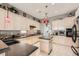 Light and bright kitchen with granite countertops, an island, mosaic backsplash, and modern appliances at 2110 King Mesa Dr, Henderson, NV 89012