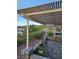 Charming outdoor patio featuring a covered pergola, stone pavers, and beautifully landscaped surroundings at 2110 King Mesa Dr, Henderson, NV 89012