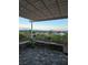 Outdoor patio area with stone pavers, covered pergola, manicured landscaping, and mountain views at 2110 King Mesa Dr, Henderson, NV 89012