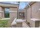 Side entrance features a decorative metal gate, a desert-scape, and neutral tones at 2110 King Mesa Dr, Henderson, NV 89012