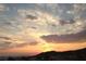 A stunning sunset over the neighborhood with soft orange and blue colors filling the expansive sky at 2110 King Mesa Dr, Henderson, NV 89012