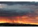 Dramatic sunset view with vibrant colors and a silhouette of mountains in the background, creating a picturesque scene at 2110 King Mesa Dr, Henderson, NV 89012