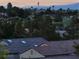 A neighborhood view featuring palm trees, green golf course, and a distant view of the city skyline at 2110 King Mesa Dr, Henderson, NV 89012