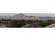 Picturesque landscape showing rooftops and trees against a backdrop of mountains and clear sky, highlighting natural beauty at 2110 King Mesa Dr, Henderson, NV 89012