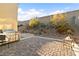 Beautiful backyard features a built-in outdoor grill area and landscaped rock garden at 2128 Delmar Farms Ct, Laughlin, NV 89029