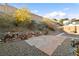 Well maintained backyard with lush landscaping, rock features, and steps to a higher tier at 2128 Delmar Farms Ct, Laughlin, NV 89029