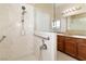The shower features grab bars and a handheld shower head for safety and convenience at 2128 Delmar Farms Ct, Laughlin, NV 89029