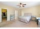 This bedroom offers a ceiling fan, carpet flooring and a walk-in closet at 2128 Delmar Farms Ct, Laughlin, NV 89029