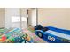 bedroom with a race car bed and blue carpet at 2128 Delmar Farms Ct, Laughlin, NV 89029