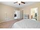 This bedroom offers a ceiling fan, carpet flooring and a private bathroom at 2128 Delmar Farms Ct, Laughlin, NV 89029