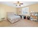 This bedroom offers a ceiling fan, a window, carpet flooring and neutral paint at 2128 Delmar Farms Ct, Laughlin, NV 89029